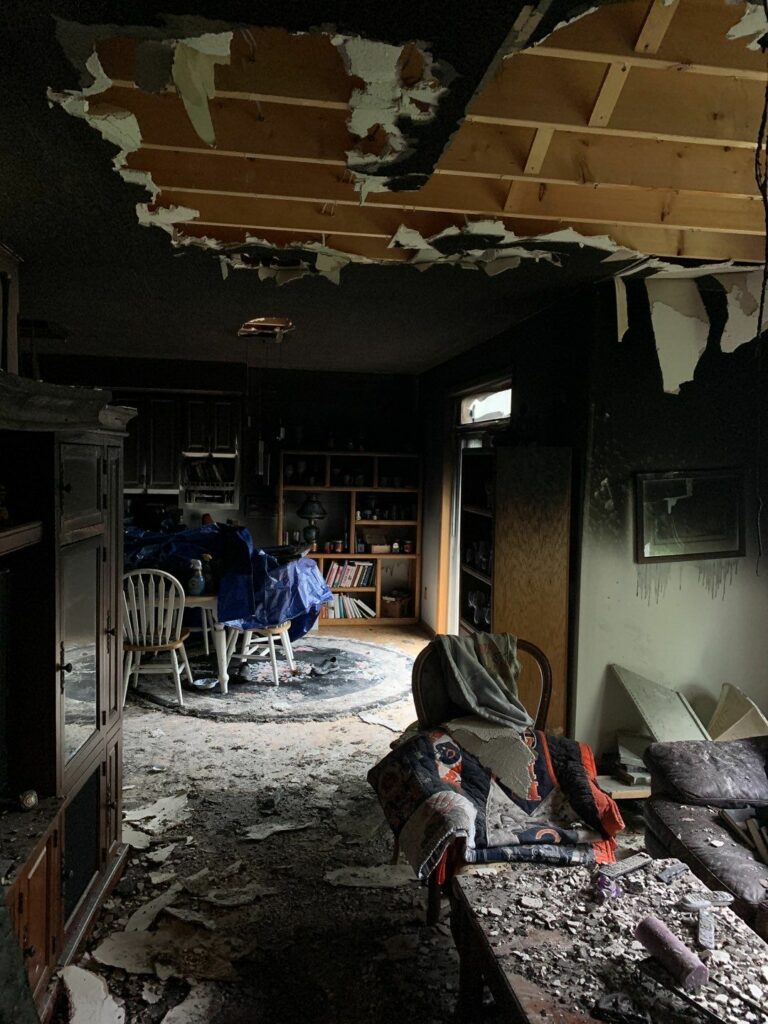 a room with fire damage and debris all over