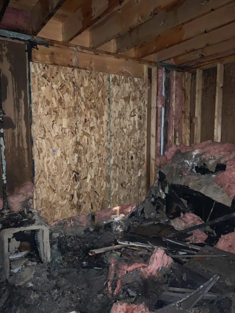 a room that has been boarded up with fire damage