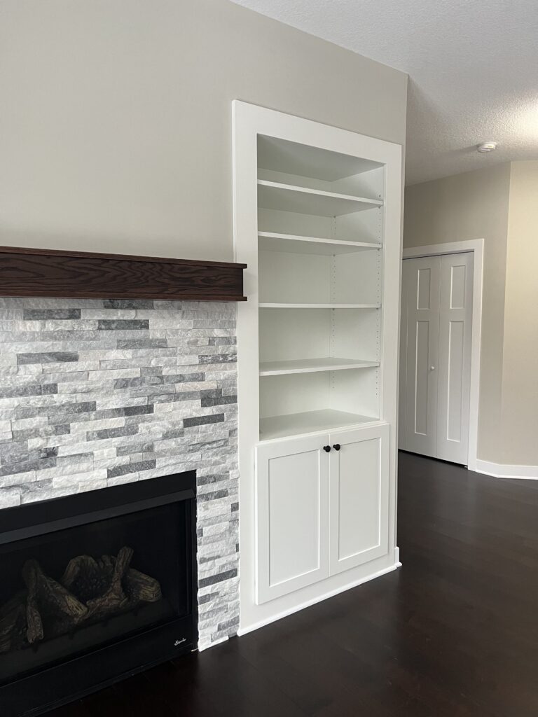 white shelves in a room with a fireplace