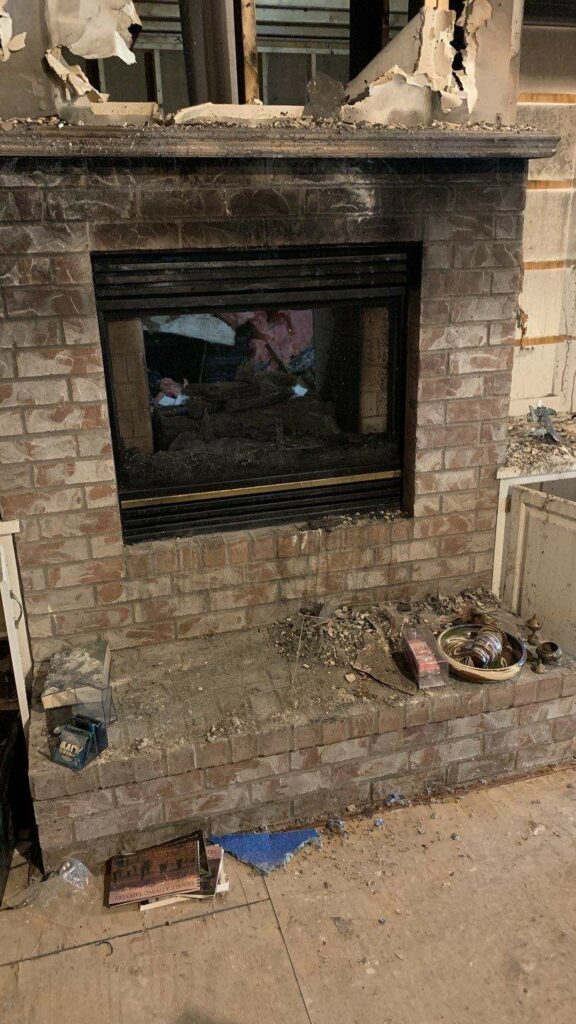 a fireplace in a room that had fire damage