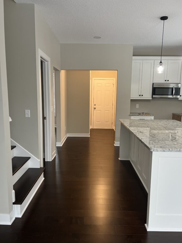 a kitchen and dining room with a wood floor