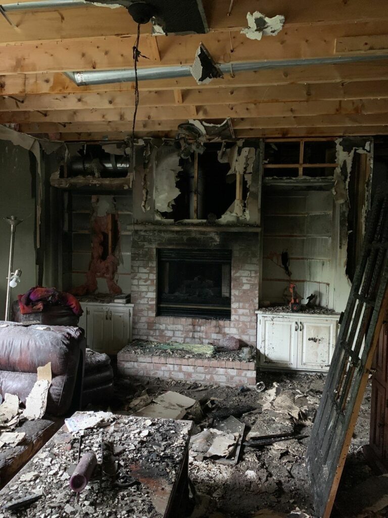 a room with fire damage and a fireplace in it