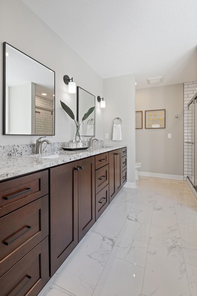 a bathroom with marble floor and marble counter tops